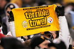 PITTSBURGH - JANUARY 23:  A fan holds up a 'terrible towel' as the New England Patriots take on the Pittsburgh Steelers in the AFC championship game at Heinz Field on January 23, 2005 in Pittsburgh, Pennsylvania. The Patriots defeated the Steelers 41-27. (Photo by Andy Lyons/Getty Images)
