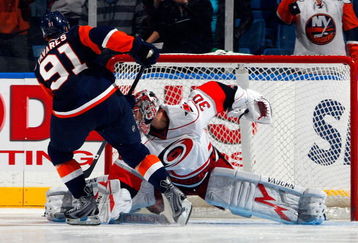 UNIONDALE, NY - OCTOBER 21:  John Tavares #91 of the New York Islanders scores the game winning shoot out goal against Cam Ward #30 of the Carolina Hurricanes on October 21, 2009 at Nassau Coliseum in Uniondale, New York. The Isles won the game 4-3 after a shoot out.  (Photo by Jim McIsaac/Getty Images)