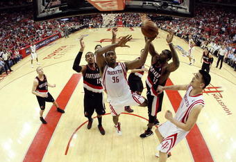 HOUSTON - APRIL 30:  Forward Ron Artest #96 of the Houston Rockets takes a shot against Greg Oden #52 and LaMarcus Aldridge #12 of the Portland Trail Blazers in Game Six of the Western Conference Quarterfinals during the 2009 NBA Playoffs at Toyota Center on April 30, 2009 in Houston, Texas. NOTE TO USER: User expressly acknowledges and agrees that, by downloading and or using this photograph, User is consenting to the terms and conditions of the Getty Images License Agreement.  (Photo by Ronald Martinez/Getty Images)
