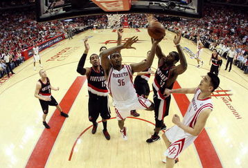 HOUSTON - APRIL 30:  Forward Ron Artest #96 of the Houston Rockets takes a shot against Greg Oden #52 and LaMarcus Aldridge #12 of the Portland Trail Blazers in Game Six of the Western Conference Quarterfinals during the 2009 NBA Playoffs at Toyota Center on April 30, 2009 in Houston, Texas. NOTE TO USER: User expressly acknowledges and agrees that, by downloading and or using this photograph, User is consenting to the terms and conditions of the Getty Images License Agreement.  (Photo by Ronald Martinez/Getty Images)