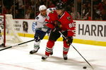 CHICAGO - OCTOBER 21: Patrick Kane #88 of the Chicago Blackhawks looks to pass under pressure from Tanner Glass #15 of the Vancouver Canucks at the United Center on October 14, 2009 in Chicago, Illinois. (Photo by Jonathan Daniel/Getty Images)
