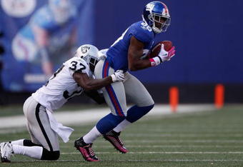 EAST RUTHERFORD, NJ - OCTOBER 11:  Hakeem Nicks #88 of the New York Giants  shakes off Chris Johnson #37 of the Oakland Raiders during the game on October 11, 2009 at Giants Stadium in East Rutherford, New Jersey.  (Photo by Jared Wickerham/Getty Images)
