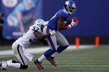 EAST RUTHERFORD, NJ - OCTOBER 11:  Hakeem Nicks #88 of the New York Giants  shakes off Chris Johnson #37 of the Oakland Raiders during the game on October 11, 2009 at Giants Stadium in East Rutherford, New Jersey.  (Photo by Jared Wickerham/Getty Images)