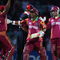 LONDON, ENGLAND - JUNE 15:  Ramnaresh Sarwan (R) and Shivnarine Chanderpaul of West Indies celebrate victory with Dwayne Bravo (L) during the ICC World Twenty20 Super Eights match between England and West Indies at the Brit Oval on June 15, 2009 in London, England.  (Photo by Tom Shaw/Getty Images)