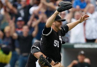 CHICAGO, IL - JULY 23: Pitcher Mark Buehrle #56 of the Chicago White Sox celebrates after pitching a perfect game as he is grabbed by first baseman Josh Fields #7 against the Tampa Bay Rays at U.S. Cellular Field on July 23, 2009 in Chicago, Illinois. The White Sox defeated the Rays 5-0, as Buehrle became the 18th pitcher in 132 years of major league baseball to throw a perfect game. (Photo by Scott Boehm/Getty Images)