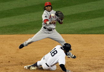 NEW YORK - OCTOBER 17: Erick Aybar #2 of the Los Angeles Angels of Anaheim throws to first base after forcing Johnny Damon #18 of the New York Yankees out at second base in Game Two of the ALCS during the 2009 MLB Playoffs at Yankee Stadium on October 17, 2009 in the Bronx borough of New York City. (Photo by Jim McIsaac/Getty Images) 