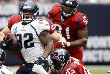 HOUSTON - SEPTEMBER 27:  Running back Maurice Jones-Drew #32 of the Jacksonville jaguars rushes for yardage in the fourth quarter as defensive tackle Jeff Zgonina #92 of the Houston Texans makes the tackle during the game at Reliant Stadium on September 27, 2009 in Houston, Texas.  (Photo by Bob Levey/Getty Images)