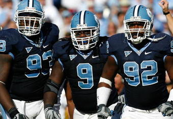 CHAPEL HILL, NC - NOVEMBER 08:  Cam Thomas #93, Marvin Austin #9 and E.J. Wilson #92 of the North Carolina Tar Heels celebrate after a defensive stop against the Georgia Tech Yellow Jackets during the game at Kenan Stadium on November 8, 2008 in Chapel Hill, North Carolina.  (Photo by Kevin C. Cox/Getty Images)