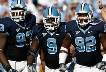 CHAPEL HILL, NC - NOVEMBER 08:  Cam Thomas #93, Marvin Austin #9 and E.J. Wilson #92 of the North Carolina Tar Heels celebrate after a defensive stop against the Georgia Tech Yellow Jackets during the game at Kenan Stadium on November 8, 2008 in Chapel Hill, North Carolina.  (Photo by Kevin C. Cox/Getty Images)