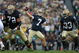 SOUTH BEND, IN - OCTOBER 03: Jimmy Clausen #7 of the Notre Dame Fighting Irish passes the ball as teammates Paul Duncan #72 and Robert Hughes #33 look to block against the Washington Huskies on October 3, 2009 at Notre Dame Stadium in South Bend, Indiana. Notre Dame defeated Washington 37-30 in overtime. (Photo by Jonathan Daniel/Getty Images)