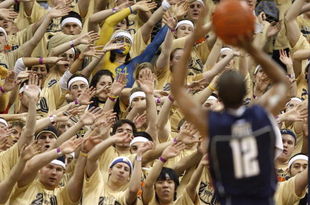 PITTSBURGH - MARCH 07: Members of the 'Oakland Zoo' try to distract A.J. Price #12 of the Connecticut Huskies while playing the Pittsburgh Panthers on March 7, 2009 at the Petersen Events Center in Pittsburgh, Pennsylvania. Pittsburgh won the game 70-60. (Photo by Gregory Shamus/Getty Images)