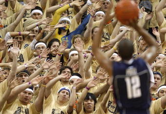 PITTSBURGH - MARCH 07: Members of the 'Oakland Zoo' try to distract A.J. Price #12 of the Connecticut Huskies while playing the Pittsburgh Panthers on March 7, 2009 at the Petersen Events Center in Pittsburgh, Pennsylvania. Pittsburgh won the game 70-60. (Photo by Gregory Shamus/Getty Images)