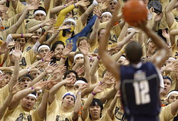 PITTSBURGH - MARCH 07: Members of the 'Oakland Zoo' try to distract A.J. Price #12 of the Connecticut Huskies while playing the Pittsburgh Panthers on March 7, 2009 at the Petersen Events Center in Pittsburgh, Pennsylvania. Pittsburgh won the game 70-60. (Photo by Gregory Shamus/Getty Images)
