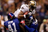 NEW ORLEANS - OCTOBER 18:  Marques Colston #12 of the New Orleans Saints makes a catch at the 1 yard line as he is tackled by C.C. Brown #41 and Antonio Pierce #58 of the New York Giants at the Louisiana Superdome on October 18, 2009 in New Orleans, Louisiana.  (Photo by Chris Graythen/Getty Images)