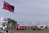 18 Mar 2001: Beneath the old Confederate States flag the the 'stars and bars'' a fan watches the racers flash past the wall during the NASCAR Winston Cup Carolina Dodge Dealers 400 at the Darlington Raceway, Darlington, South Carolina. Mandatory Credit: Donald Miralle/ALLSPORT