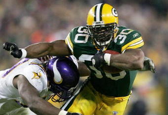 GREEN BAY, WI - NOVEMBER 14: Ahman Green #30 of the Green Bay Packers rushes as Kenny Mixon #79 of the Minnesota Vikings tries to wrap him up during a game at Lambeau Field on November 14, 2004 in Green Bay, Wisconsin. (Photo by Jonathan Daniel/Getty Images)