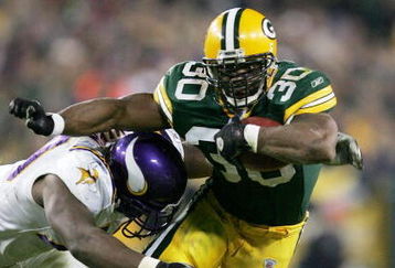 GREEN BAY, WI - NOVEMBER 14: Ahman Green #30 of the Green Bay Packers rushes as Kenny Mixon #79 of the Minnesota Vikings tries to wrap him up during a game at Lambeau Field on November 14, 2004 in Green Bay, Wisconsin. (Photo by Jonathan Daniel/Getty Images)
