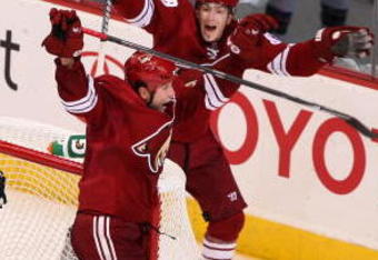 GLENDALE, AZ - OCTOBER 15:  Ed Jovanovski #55 of the Phoenix Coyotes celebrates with teammate Peter Mueller #88 after Jovanovski scored the game-winning goal in overtime past goaltender Chris Mason #50 of the St. Louis Blues during the NHL game at Jobing.com Arena on October 15, 2009 in Glendale, Arizona. The Coyotes defeated the Blues 3-2 in overtime.  (Photo by Christian Petersen/Getty Images)