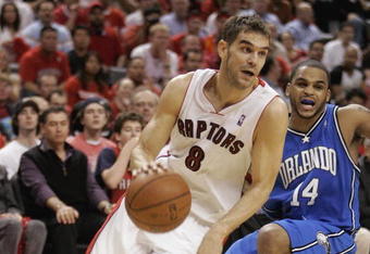 TORONTO, ON - APRIL 26:  Jose Calderon #8 of the Toronto Raptors drives past Jameer Nelson #14 of the Orlando Magic in Game Four of the Eastern Conference Quarterfinals at the Air Canada Centre April 26, 2008 in Toronto, Ontario. The Magic defeated the Raptors 106-94 to take a 3-1 series lead.  (Photo by Claus Andersen/Getty Images)