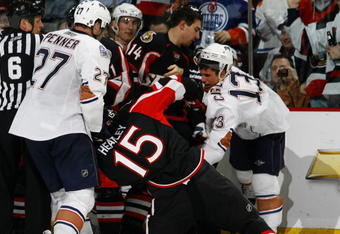 OTTAWA - MARCH 5:  Dustin Penner #27 of the Edmonton Oilers pulls Dany Heatley #15 of the Ottawa Senators off his skates during a melee late in the third period of a game on March 5, 2009 at the Scotiabank Place in Ottawa, Canada. The Ottawa Senators defeated the Edmonton Oilers 4-2. (Photo by Phillip MacCallum/Getty Images)
