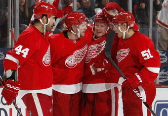 DETROIT - OCTOBER 10:  Jason Williams #29 of the Detroit Red Wings celebrates a second period goal with Nicklas Lidstrom #5, Valtteri Filppula #51 and Todd Bertuzzi #44 while playing the Washington Capitals on October 10, 2009 at Joe Louis Arena in Detroit, Michigan.  (Photo by Gregory Shamus/Getty Images)