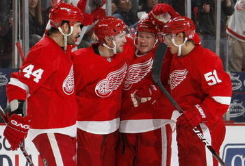 DETROIT - OCTOBER 10:  Jason Williams #29 of the Detroit Red Wings celebrates a second period goal with Nicklas Lidstrom #5, Valtteri Filppula #51 and Todd Bertuzzi #44 while playing the Washington Capitals on October 10, 2009 at Joe Louis Arena in Detroit, Michigan.  (Photo by Gregory Shamus/Getty Images)
