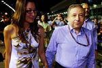 SINGAPORE - SEPTEMBER 27:  F.I.A. Presidential candidate Jean Todt and Michelle Yeoh walk on the grid before the Singapore Formula One Grand Prix at the Marina Bay Street Circuit on September 27, 2009 in Singapore.  (Photo by Mark Thompson/Getty Images)