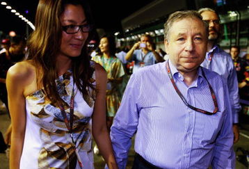 SINGAPORE - SEPTEMBER 27:  F.I.A. Presidential candidate Jean Todt and Michelle Yeoh walk on the grid before the Singapore Formula One Grand Prix at the Marina Bay Street Circuit on September 27, 2009 in Singapore.  (Photo by Mark Thompson/Getty Images)