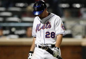 NEW YORK - SEPTEMBER 23:  Daniel Murphy #28 of the New York Mets walks to the dugout after striking out against the Atlanta Braves during the game on September 23, 2009 at Citi Field in the Flushing neighborhood of the Queens borough of New York City.  (Photo by Jared Wickerham/Getty Images)