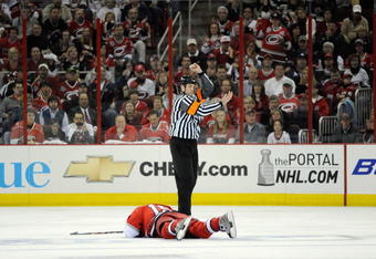 RALEIGH, NC - APRIL 21:  Tuomo Ruutu #15 of the Carolina Hurricanes lays injured on the ice against the New Jersey Devils during Game Four of the Eastern Conference Quarterfinals of the 2009 Stanley Cup Playoffs on April 21, 2009 at the RBC Center in Raleigh, North Carolina.  Carolina won 4-3. (Photo by: Grant Halverson/Getty Images)