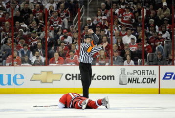 RALEIGH, NC - APRIL 21:  Tuomo Ruutu #15 of the Carolina Hurricanes lays injured on the ice against the New Jersey Devils during Game Four of the Eastern Conference Quarterfinals of the 2009 Stanley Cup Playoffs on April 21, 2009 at the RBC Center in Raleigh, North Carolina.  Carolina won 4-3. (Photo by: Grant Halverson/Getty Images)