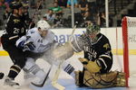 DALLAS - SEPTEMBER 16:  Goaltender Marty Turco #35 of the Dallas Stars makes a save in front of Martins Karsums #44 of the Tampa Bay Lightning and Warren Peters #25 at American Airlines Center on September 16, 2009 in Dallas, Texas.  (Photo by Ronald Martinez/Getty Images)