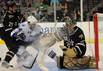 DALLAS - SEPTEMBER 16:  Goaltender Marty Turco #35 of the Dallas Stars makes a save in front of Martins Karsums #44 of the Tampa Bay Lightning and Warren Peters #25 at American Airlines Center on September 16, 2009 in Dallas, Texas.  (Photo by Ronald Martinez/Getty Images)