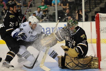DALLAS - SEPTEMBER 16:  Goaltender Marty Turco #35 of the Dallas Stars makes a save in front of Martins Karsums #44 of the Tampa Bay Lightning and Warren Peters #25 at American Airlines Center on September 16, 2009 in Dallas, Texas.  (Photo by Ronald Martinez/Getty Images)