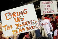 PHILADELPHIA - OCTOBER 21:  Fans of the Philadelphia Phillies hold up signs which call for the Phillies to play against the New York Yankees in the World Series after the Phillies advanced to the series with their 10-4 against the Los Angeles Dodgers in Game Five of the NLCS during the 2009 MLB Playoffs at Citizens Bank Park on October 21, 2009 in Philadelphia, Pennsylvania.  (Photo by Jeff Zelevansky/Getty Images)