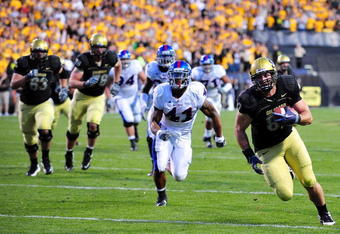 BOULDER, CO - OCTOBER 17:  Rier Geer #87 of the Colorado Buffaloes runs for a touch down against Arist Wright #41 of the Kansas Jayhawks during the game at Folsom Field on October 17, 2009 in Boulder, Colorado. (Photo by Garrett W. Ellwood/Getty Images)