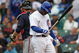 CHICAGO - JULY 08: Milton Bradley #21 of the Chicago Cubs walks back to the dugout after making the final out of the game as Brian McCann #16 of the Atlanta Braves walks to the mound on July 8, 2009 at Wrigley Field in Chicago, Illinois. The Braves defeated the Cubs 4-1. (Photo by Jonathan Daniel/Getty Images)