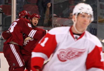 GLENDALE, AZ - OCTOBER 22:  Adrian Aucoin #33 of the Phoenix Coyotes celebrates with teammate Peter Mueller #88 after Aucoin scored the game-winning goal in overtime against the Detroit Red Wings during the NHL game at Jobing.com Arena on October 22, 2009 in Glendale, Arizona.  The Coyotes defeated the Red Wings 3-2 in overtime.  (Photo by Christian Petersen/Getty Images)