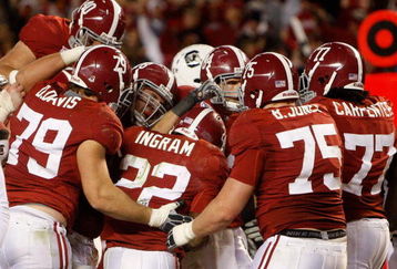 TUSCALOOSA - OCTOBER 17:  Alabama Crimson Tide teammates, including offensive lineman Drew Davis, offensive lineman Barrett Jones #75 and offensive lineman James Carpenter #77, swarm running back Mark Ingram #22 after his fourth quarter, game clinching touchdown during the game against the South Carolina Gamecocks at Bryant-Denny Stadium on October 17, 2009 in Tuscaloosa, Alabama. The Crimson Tide beat the Gamecocks 20-6.  (Photo by Mike Zarrilli/Getty Images)