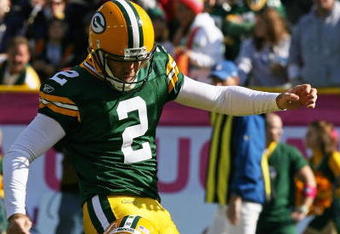 GREEN BAY, WI - OCTOBER 18: Mason Crosby #2 of the Green Bay Packers kicks a n extra point out of the hold of Matt Flynn #10 against the Detroit Lions rushes at Lambeau Field on October 18, 2009 in Green Bay, Wisconsin. The Packers defeated the Lions 26-0.  (Photo by Jonathan Daniel/Getty Images)