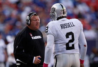 EAST RUTHERFORD, NJ - OCTOBER 11:  Head Coach Tom Cable and JaMarcus Russell #2 of the Oakland Raiders talk in between plays during the game on October 11, 2009 at Giants Stadium in East Rutherford, New Jersey.  (Photo by Jared Wickerham/Getty Images)