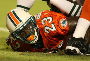 MIAMI - OCTOBER 12:  Running back Ronnie Brown #23 of the Miami Dolphins scores a touchdown against the New York Jets fans prior to their game at Land Shark Stadium on October 12, 2009 in Miami, Florida. Miami defeated New York 31-27.  (Photo by Marc Serota/Getty Images)