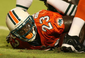 MIAMI - OCTOBER 12:  Running back Ronnie Brown #23 of the Miami Dolphins scores a touchdown against the New York Jets fans prior to their game at Land Shark Stadium on October 12, 2009 in Miami, Florida. Miami defeated New York 31-27.  (Photo by Marc Serota/Getty Images)