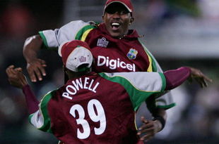 PORT ELIZABETH, SOUTH AFRICA - DECEMBER 16:  Daren Powell of West Indies celebrates with Dwayne Bravo after running out Albie Morkel of South Africa during the Standard Bank International Pro20 match between South Africa and West Indies held at Sahara Oval December 16, 2007 in St Georges, Port Elizabeth, South Africa. (Photo by Duif du Toit/Gallo Images/Getty Images)