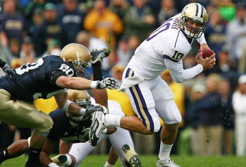SOUTH BEND, IN - OCTOBER 03: Jake Locker #10 of the Washington Huskies runs away from John Ryan #90 of the Notre Dame Fighting Irish on October 3, 2009 at Notre Dame Stadium in South Bend, Indiana. Notre Dame defeated Washington 37-30. (Photo by Jonathan Daniel/Getty Images)