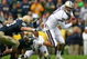 SOUTH BEND, IN - OCTOBER 03: Jake Locker #10 of the Washington Huskies runs away from John Ryan #90 of the Notre Dame Fighting Irish on October 3, 2009 at Notre Dame Stadium in South Bend, Indiana. Notre Dame defeated Washington 37-30. (Photo by Jonathan Daniel/Getty Images)