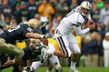 SOUTH BEND, IN - OCTOBER 03: Jake Locker #10 of the Washington Huskies runs away from John Ryan #90 of the Notre Dame Fighting Irish on October 3, 2009 at Notre Dame Stadium in South Bend, Indiana. Notre Dame defeated Washington 37-30. (Photo by Jonathan Daniel/Getty Images)