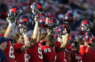 DALLAS - NOVEMBER 29:  Members of the Southern Methodist University Mustangs cheer the start of the second half against the Texas Christian University Horned Frogs despite looking at an 0-11 season November 29, 2003 at Gerald J. Ford Stadium in Dallas, Texas.  TCU won 20-13.  (Photo by Brian Bahr/Getty Images)