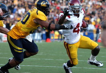 BERKELEY, CA - OCTOBER 03:  Joe McKnight #4 of the USC Trojans runs against Mychal Kendricks #30 of the California Golden Bears at Memorial Stadium on October 3, 2009 in Berkeley, California.  (Photo by Jed Jacobsohn/Getty Images)