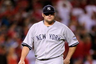 ANAHEIM, CA - OCTOBER 22:  Joba Chamberlain #62 of the New York Yankees leaves the mound after being relieved by teammate Mariano Rivera #42 (Not Shown) during the eight inning in Game Five of the ALCS against the Los Angeles Angels of Anaheim during the 2009 MLB Playoffs at Angel Stadium on October 22, 2009 in Anaheim, California.  (Photo by Kevork Djansezian/Getty Images)
